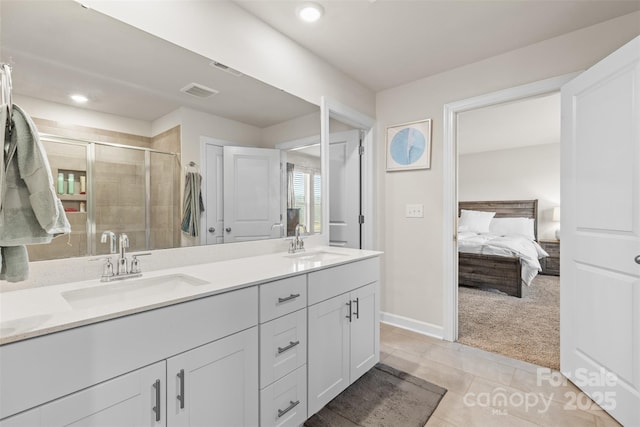 full bath with double vanity, visible vents, a stall shower, and a sink