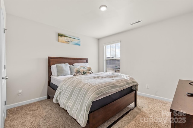 carpeted bedroom featuring visible vents and baseboards