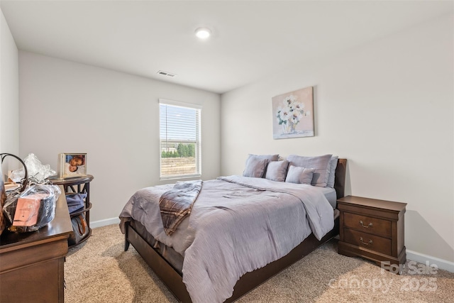 bedroom featuring light carpet, visible vents, and baseboards