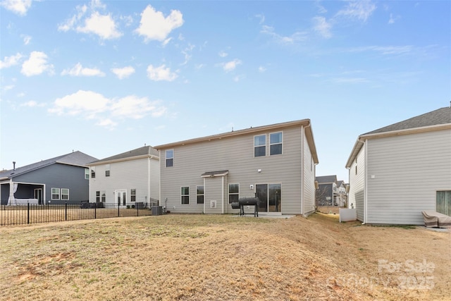 back of property featuring a lawn, central AC, and fence