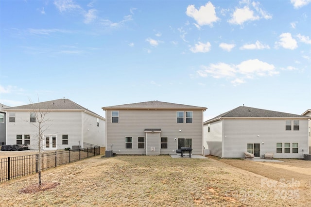 rear view of house featuring cooling unit and a fenced backyard