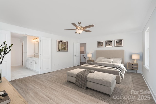 bedroom with light wood-style floors, a ceiling fan, baseboards, and ensuite bathroom