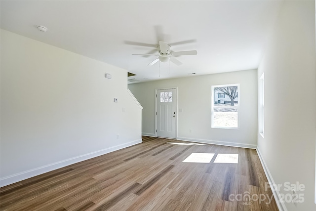 entryway with ceiling fan, baseboards, and wood finished floors