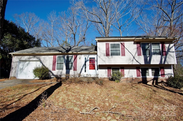 split level home featuring aphalt driveway and an attached garage