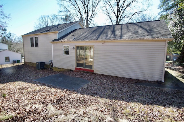 rear view of property with roof with shingles, crawl space, a patio, and cooling unit