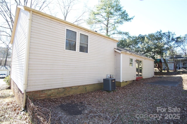 view of property exterior with central air condition unit and crawl space