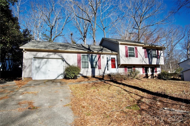 tri-level home with an attached garage and driveway