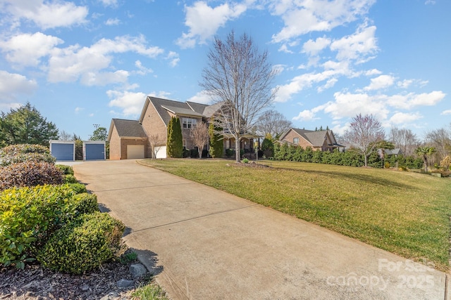 view of front facade featuring concrete driveway and a front yard