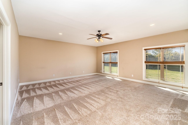 carpeted spare room featuring ceiling fan, baseboards, and recessed lighting