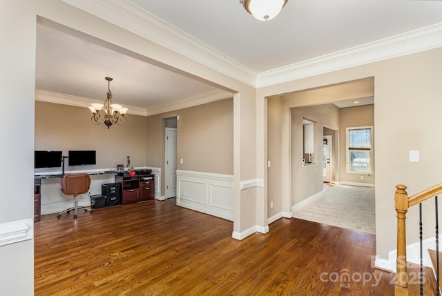 home office with a chandelier, ornamental molding, wainscoting, and wood finished floors