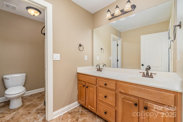 full bathroom with baseboards, visible vents, a sink, and toilet