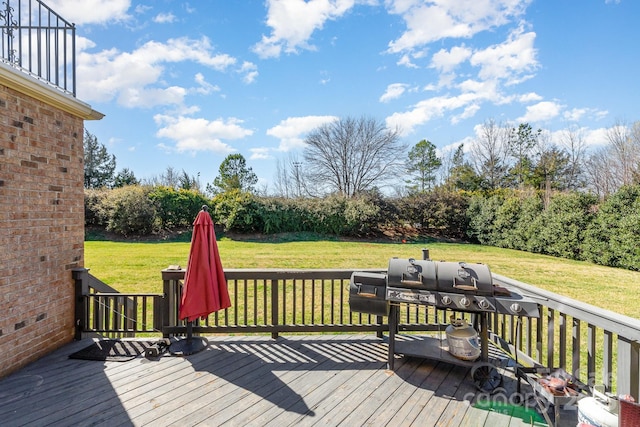 wooden deck featuring a yard and area for grilling