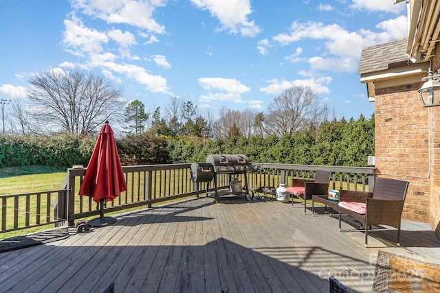 wooden deck with a yard and area for grilling