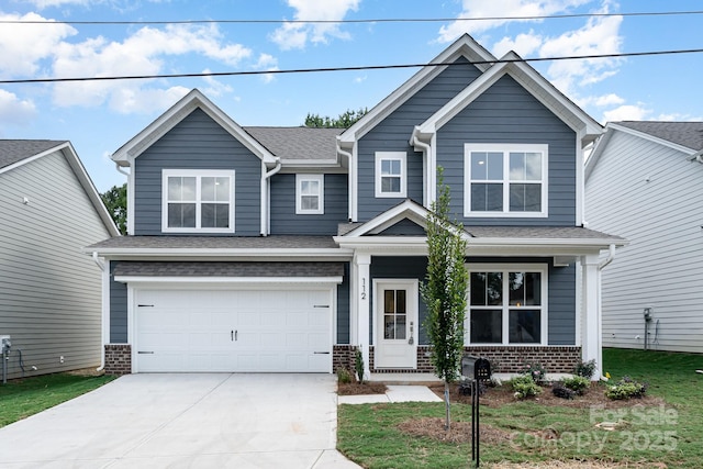 craftsman-style home featuring a garage, driveway, a shingled roof, a porch, and brick siding