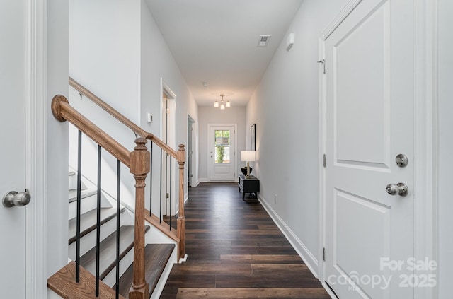 interior space with visible vents, stairs, baseboards, and dark wood-type flooring