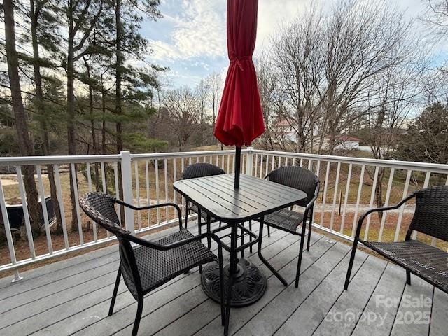 wooden terrace with outdoor dining area