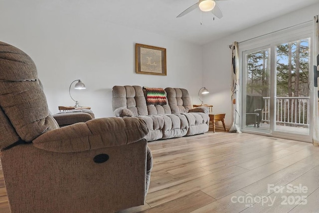 living room with wood finished floors and a ceiling fan
