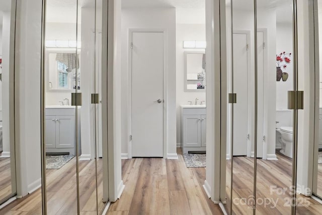 corridor featuring light wood-style flooring