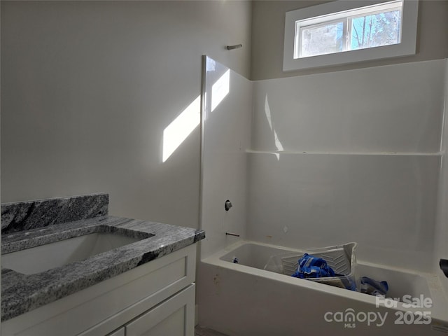 full bath featuring a bathtub and vanity