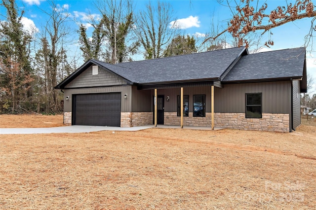 view of front of home with a garage, covered porch, stone siding, and driveway