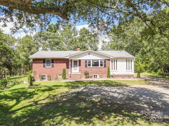 ranch-style house featuring a front yard, brick siding, a chimney, and entry steps