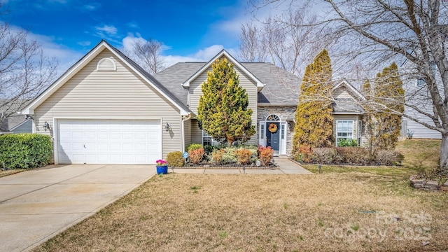 view of front facade featuring an attached garage, stone siding, concrete driveway, and a front yard