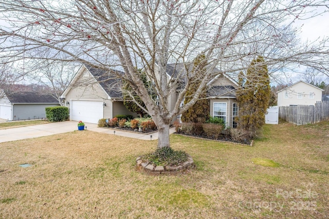 view of front of property featuring a garage, fence, driveway, and a front lawn