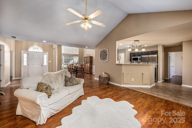 living room featuring lofted ceiling, dark wood-style flooring, and baseboards