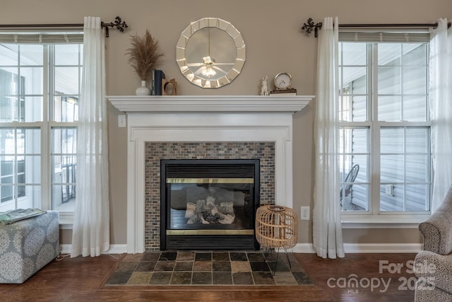 room details with a tile fireplace and baseboards