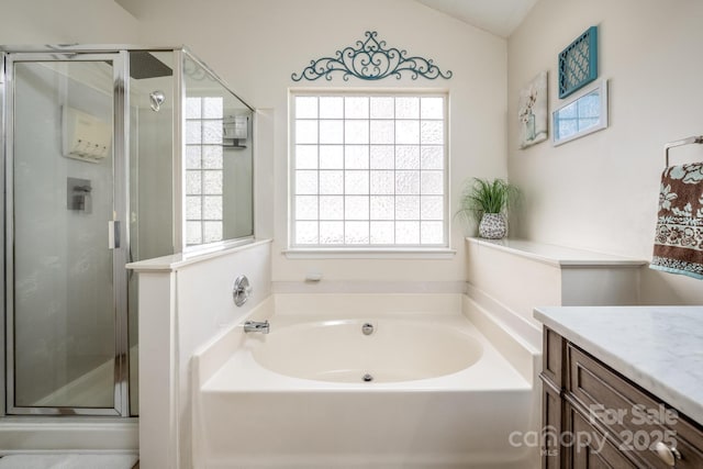 full bath with vaulted ceiling, a stall shower, a garden tub, and vanity