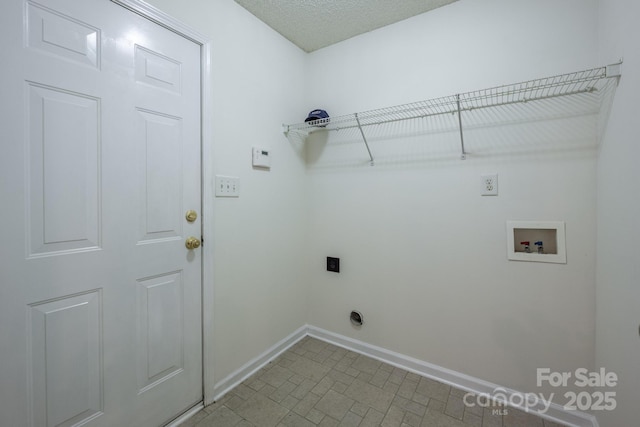 laundry area featuring a textured ceiling, hookup for a washing machine, hookup for an electric dryer, laundry area, and baseboards