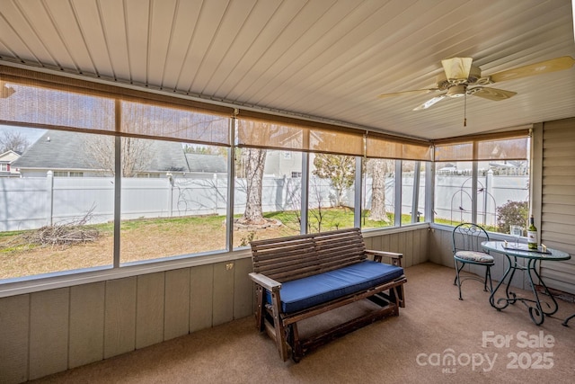 sunroom / solarium featuring ceiling fan