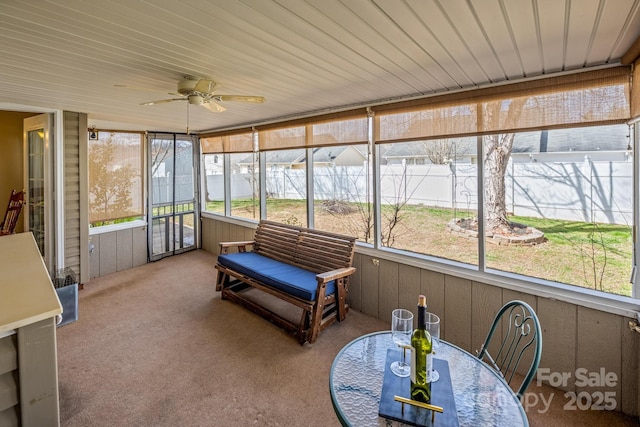 sunroom / solarium featuring wooden ceiling and a ceiling fan