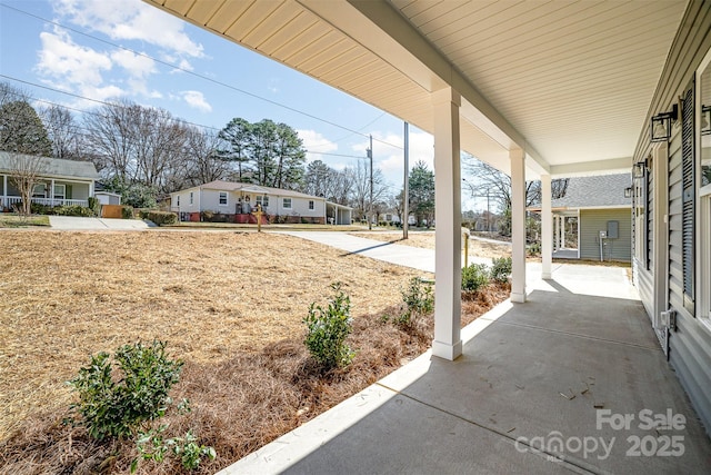 view of patio / terrace with a residential view and a porch