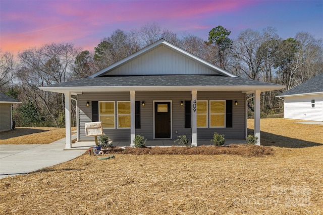 view of front of property featuring a porch and roof with shingles