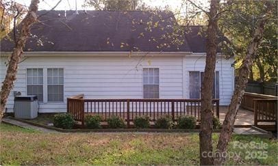 back of property with a deck and central air condition unit