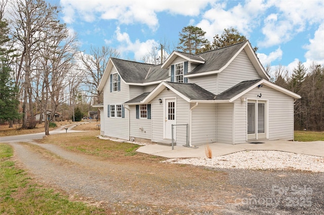 view of front of home with entry steps and roof with shingles