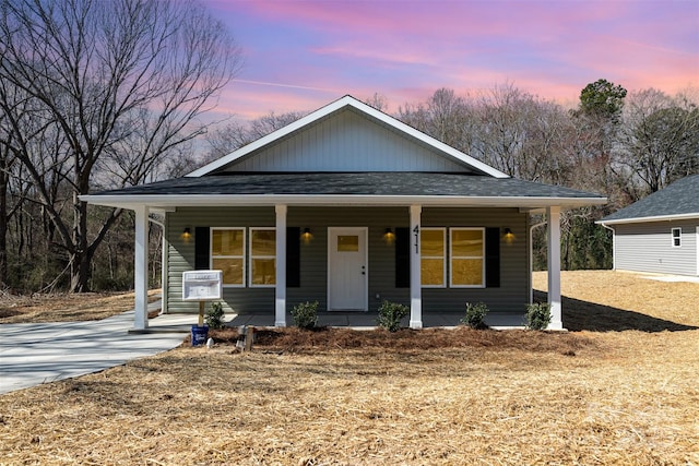 bungalow-style home featuring a shingled roof and a porch