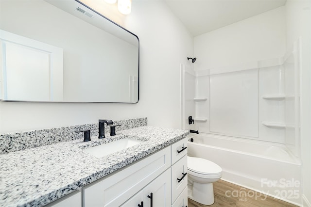 full bathroom featuring toilet, shower / bath combination, wood finished floors, vanity, and visible vents