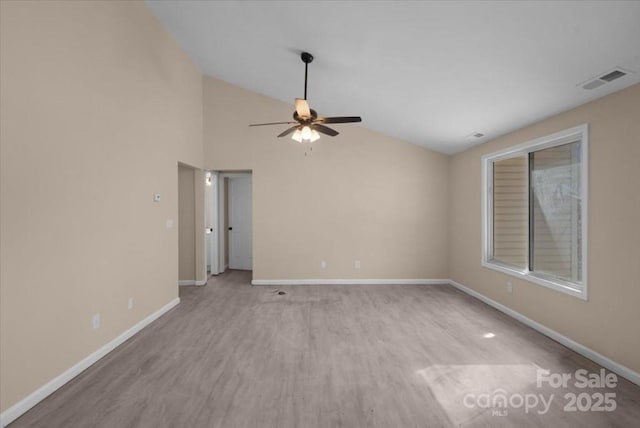 spare room featuring a ceiling fan, visible vents, baseboards, and wood finished floors