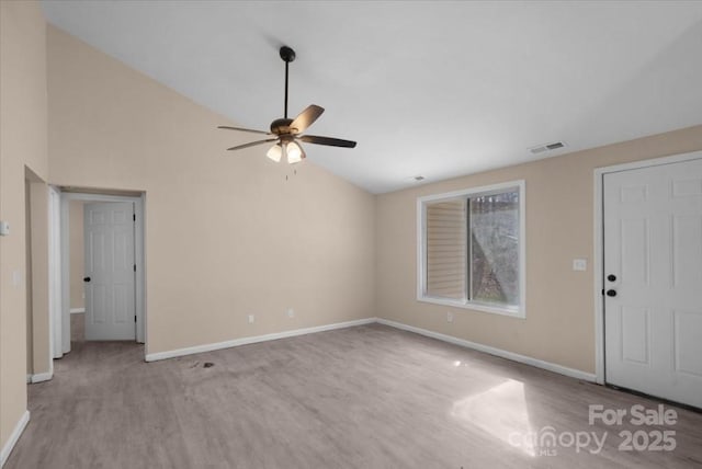 interior space featuring visible vents, baseboards, a ceiling fan, wood finished floors, and high vaulted ceiling