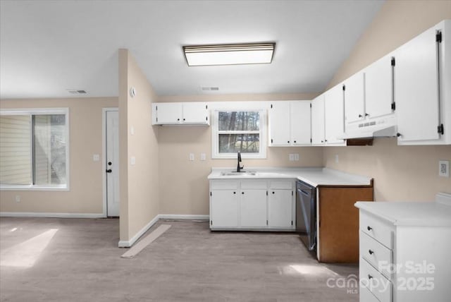 kitchen featuring visible vents, stainless steel dishwasher, white cabinetry, a sink, and under cabinet range hood