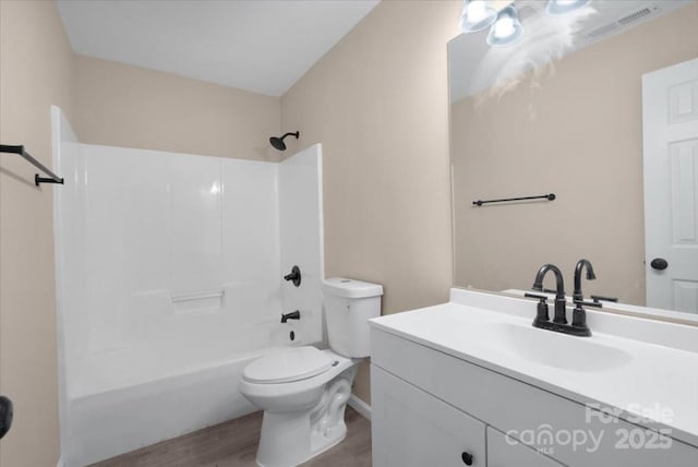 full bath with toilet, tub / shower combination, wood finished floors, and vanity