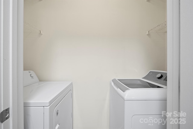 washroom featuring laundry area and washing machine and dryer