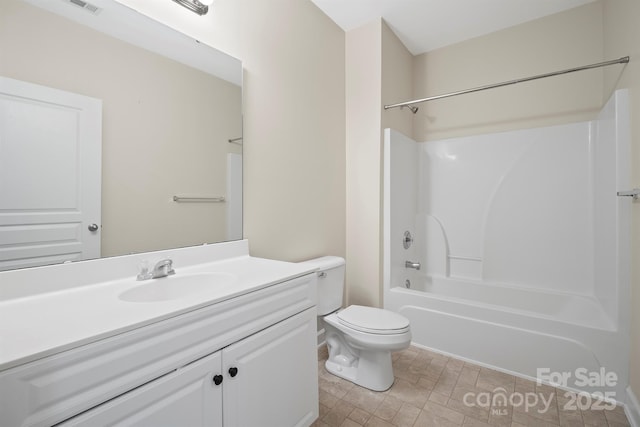 bathroom featuring toilet, washtub / shower combination, and vanity