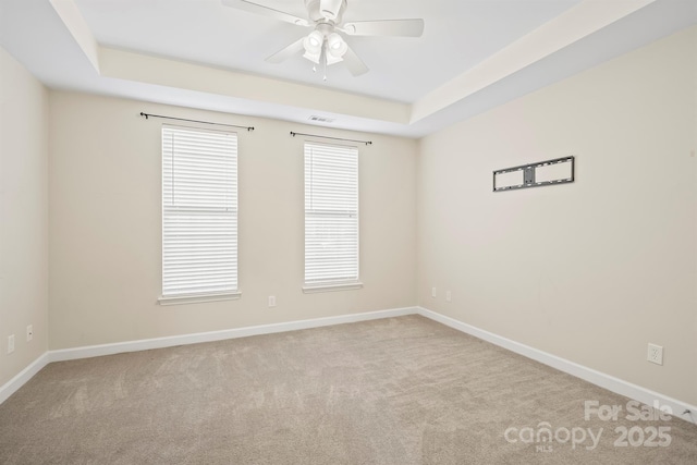 unfurnished room with carpet flooring, visible vents, and baseboards