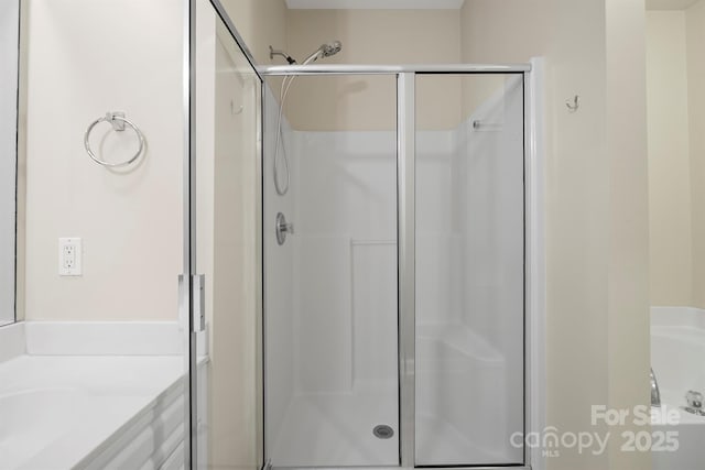 bathroom featuring a stall shower and vanity