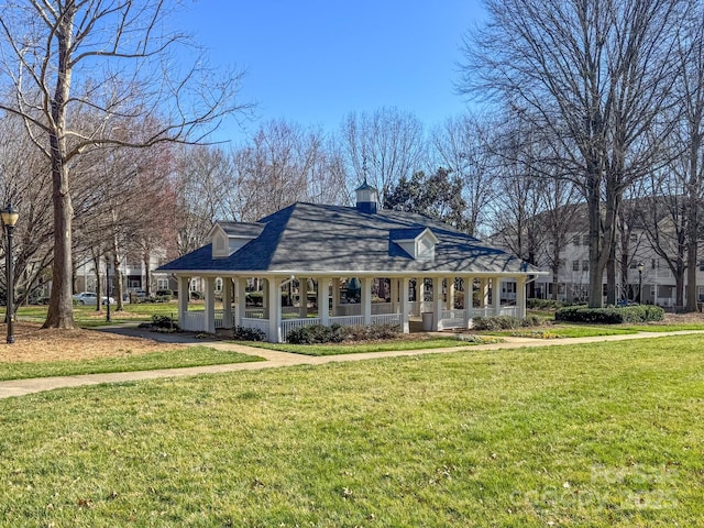 view of front of house featuring covered porch and a front lawn