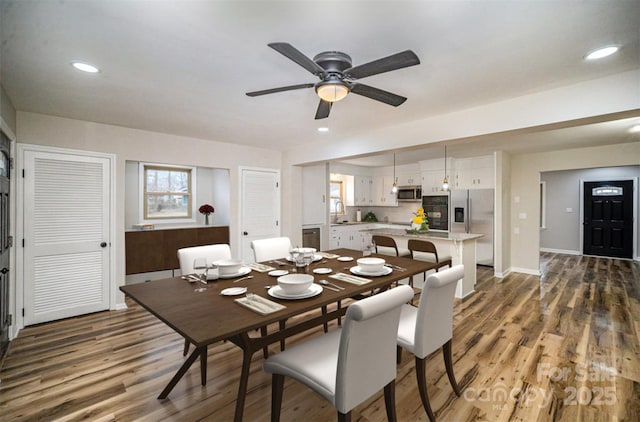 dining room featuring ceiling fan, baseboards, wood finished floors, and recessed lighting