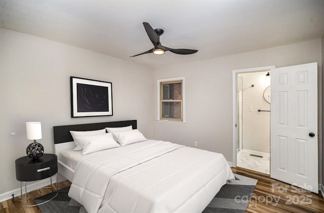 bedroom with ensuite bath, ceiling fan, baseboards, and wood finished floors